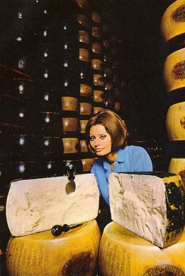 Posing with wheels of cheese - "Meet my new friends"